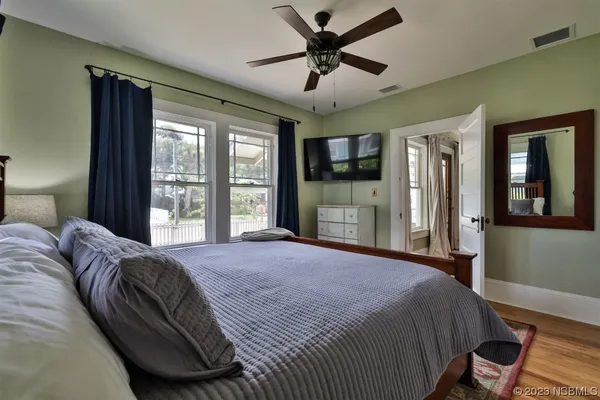 a view of a patio with table and chairs potted plants with wooden floor and floor