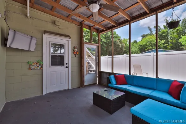 a living room with furniture and a flat screen tv