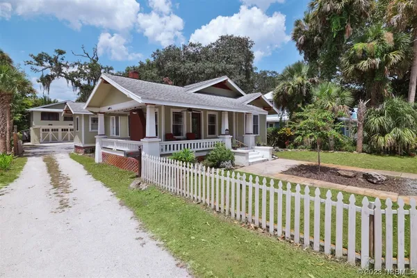 a living room with furniture and flowers