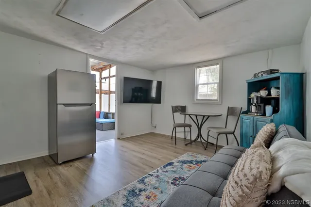a view of an entryway with wooden floor and cabinet