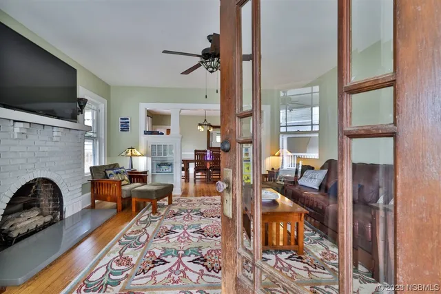 a living room with furniture a flat screen tv and a fireplace