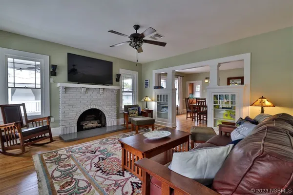 a living room with furniture fireplace and flat screen tv