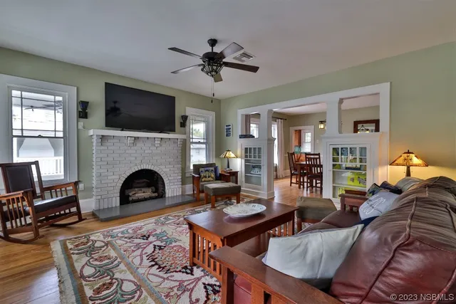 a living room with furniture fireplace and flat screen tv