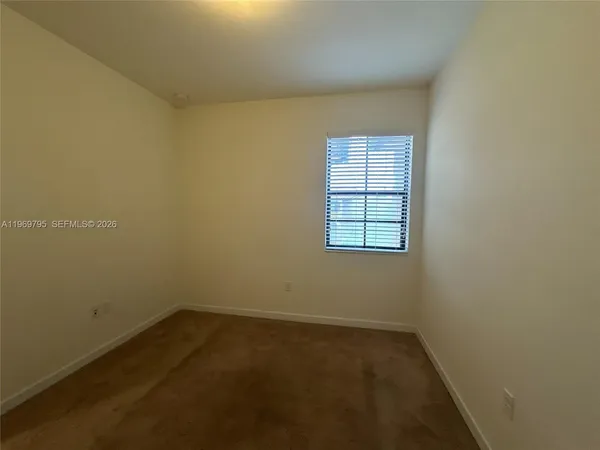 a white toilet sitting next to a shower