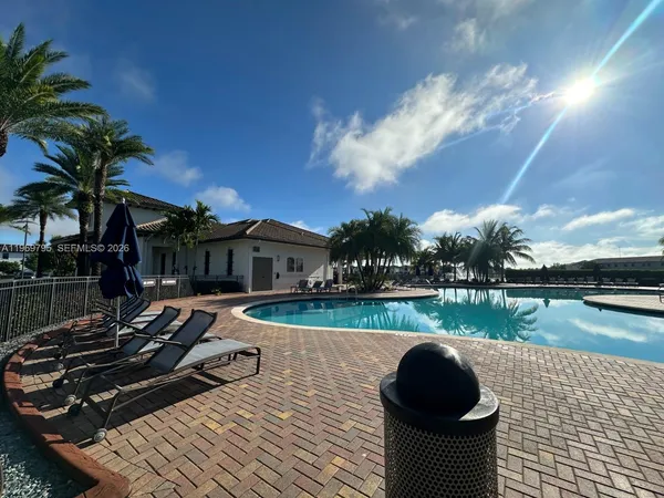 a row of palm trees sitting in front of a building
