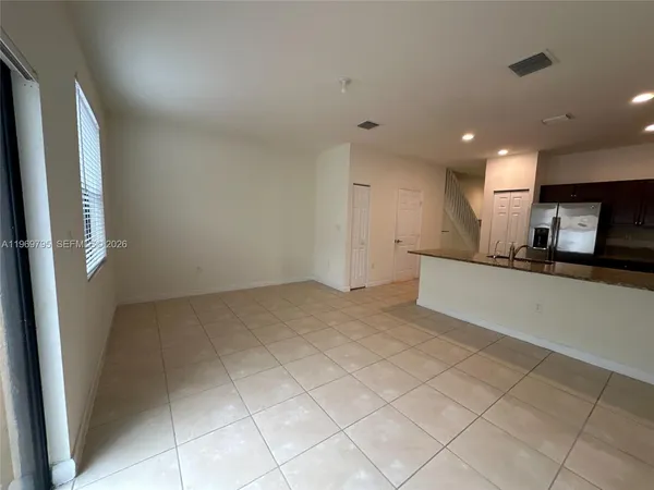 a view of a kitchen with a sink and cabinets