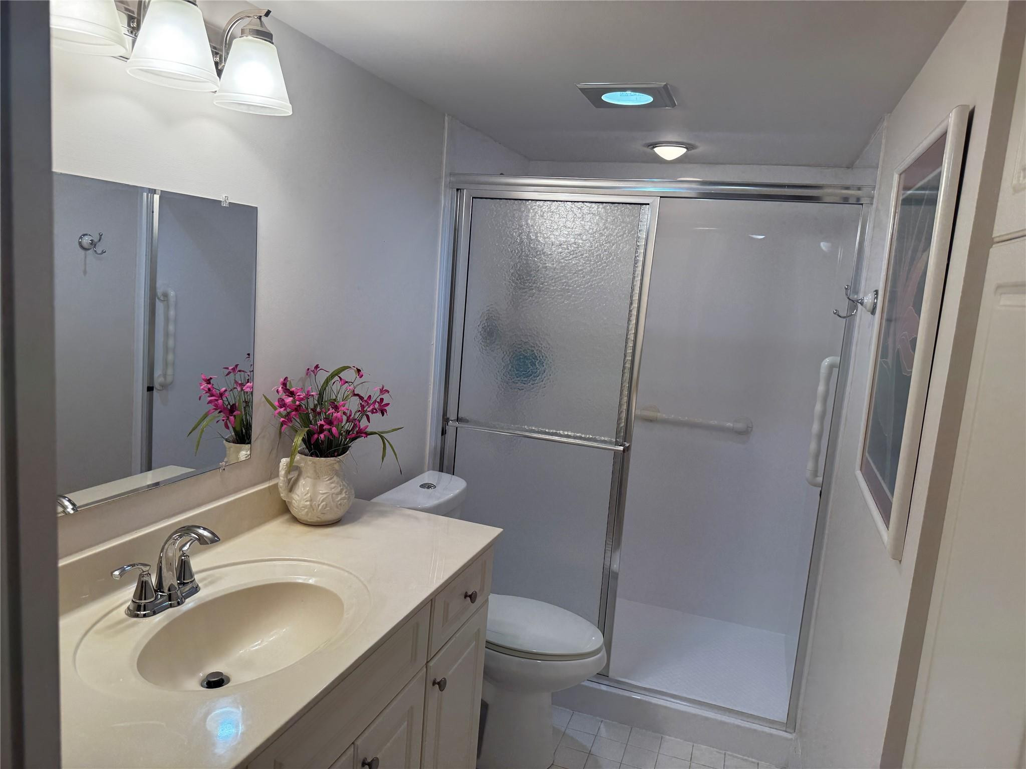 3302 Aruba Way, Unit M1 Coconut Creek, FL 33066 - Photo 12 of 58 a bathroom with a sink toilet and shower