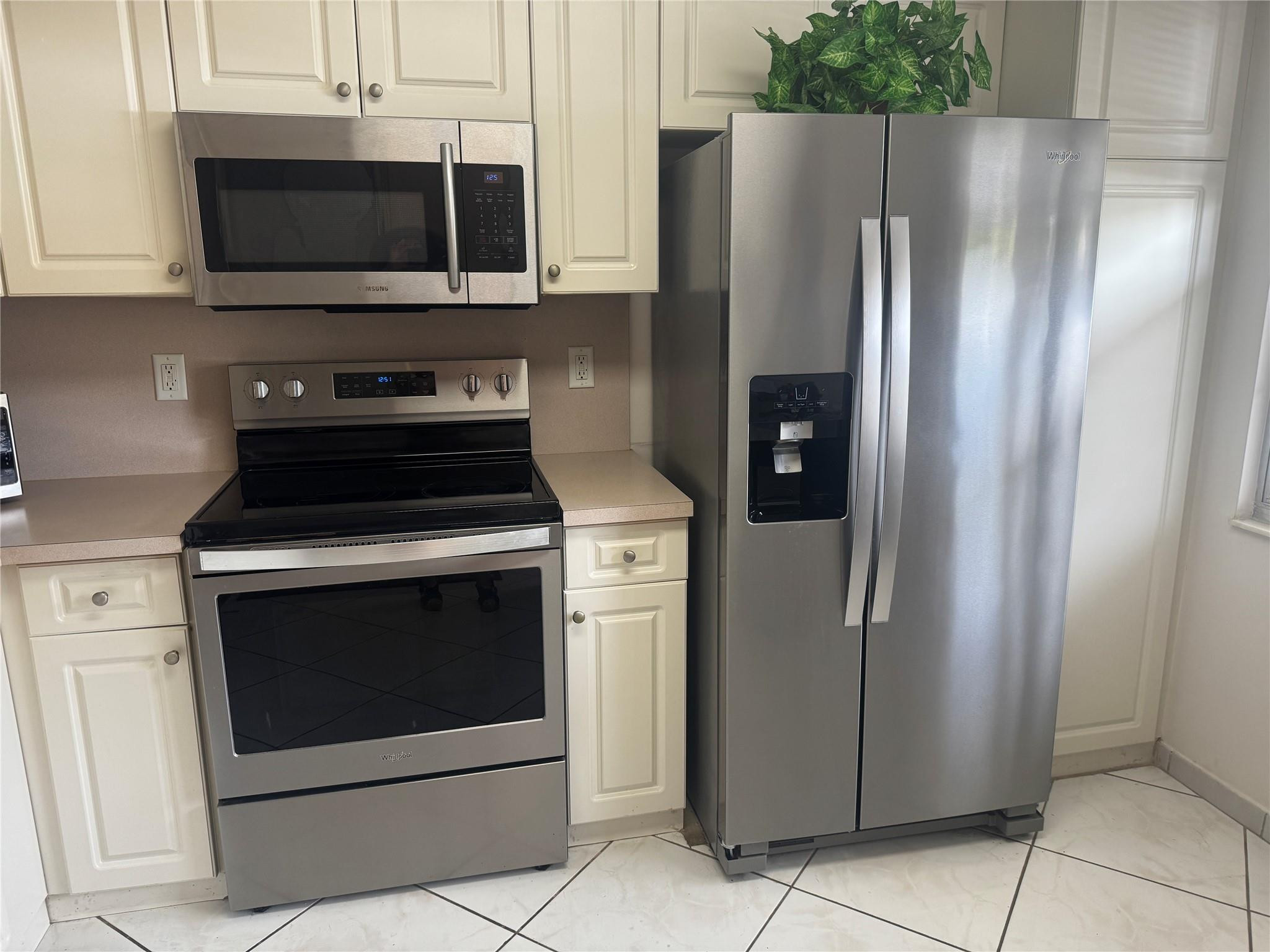 3302 Aruba Way, Unit M1 Coconut Creek, FL 33066 - Photo 2 of 58 a kitchen with stainless steel appliances a refrigerator a stove and cabinets