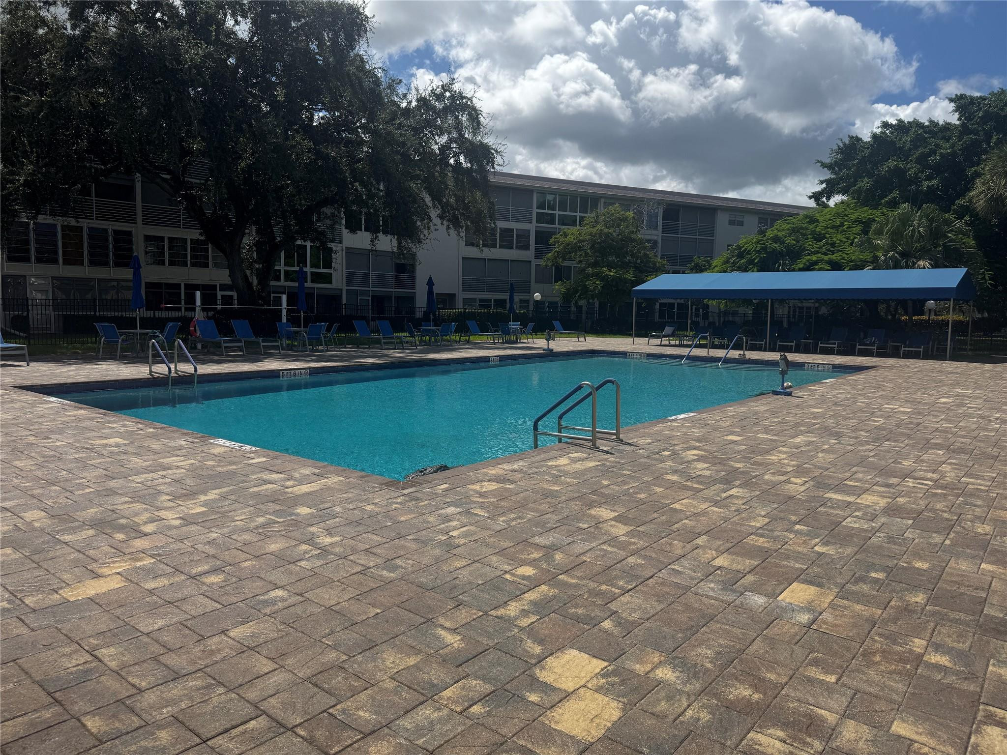 3302 Aruba Way, Unit M1 Coconut Creek, FL 33066 - Photo 23 of 58 a view of swimming pool with wooden fence