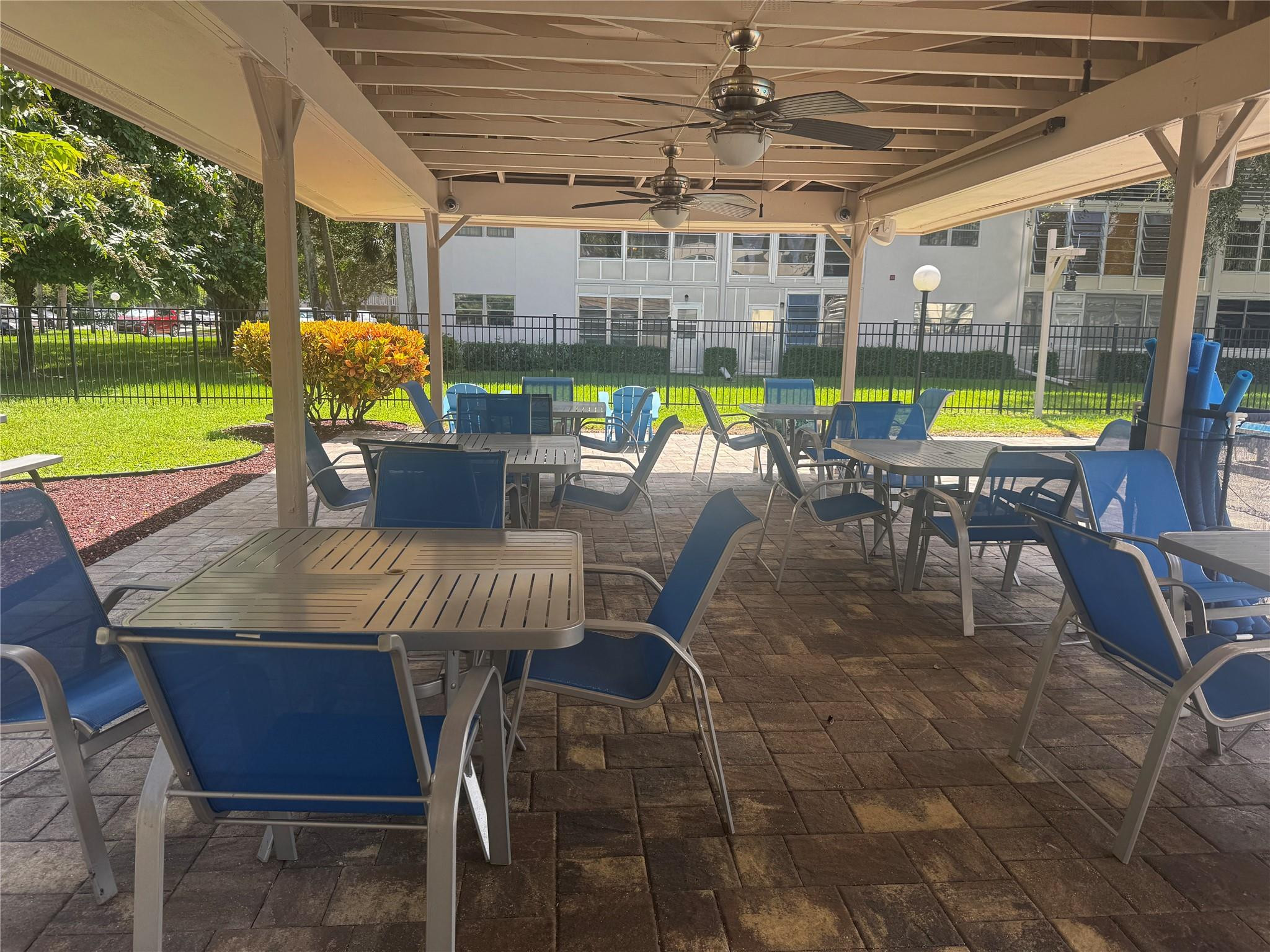 3302 Aruba Way, Unit M1 Coconut Creek, FL 33066 - Photo 26 of 58 a view of a swimming pool and outdoor seating