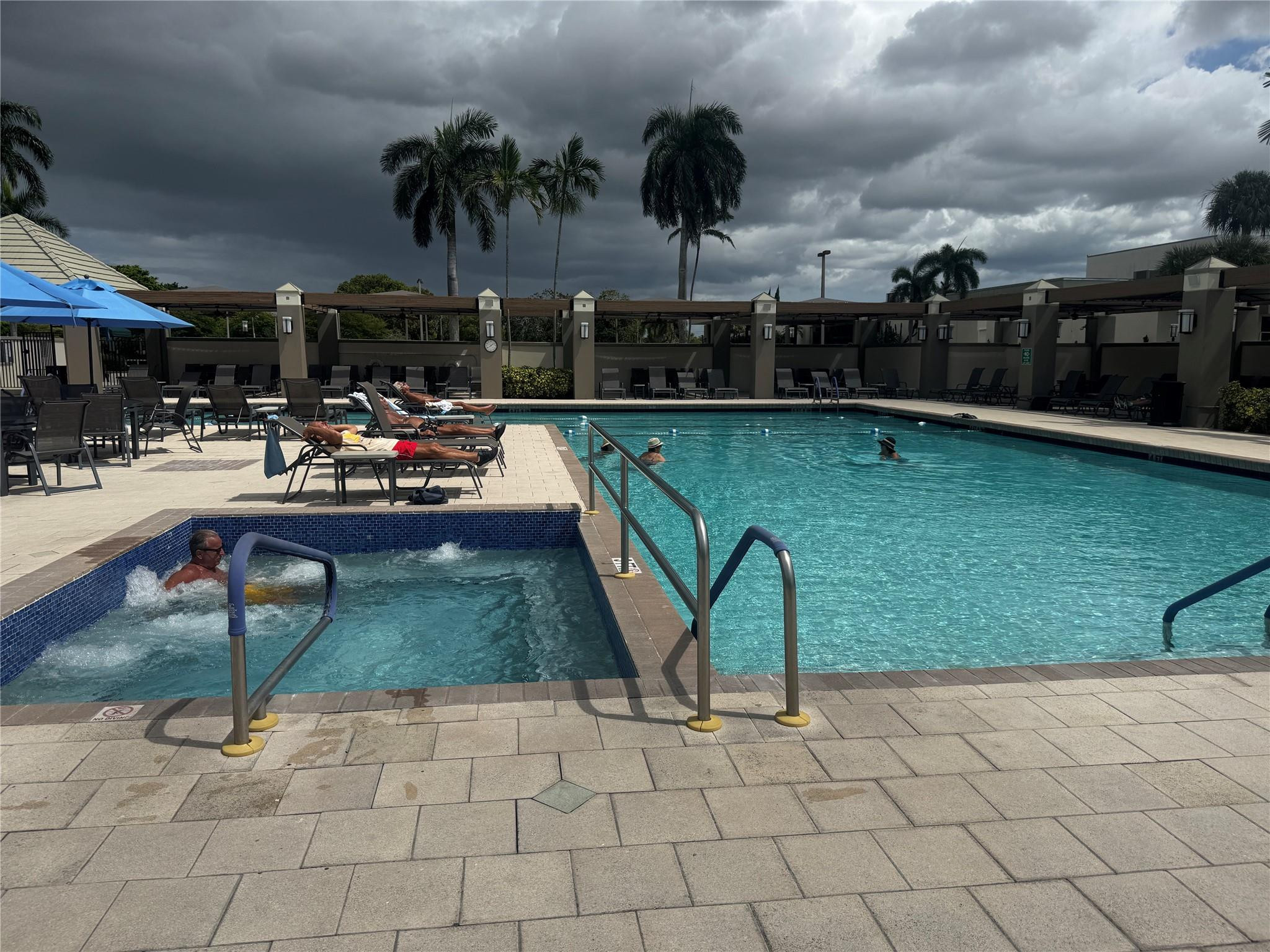 3302 Aruba Way, Unit M1 Coconut Creek, FL 33066 - Photo 32 of 58 a view of a backyard and swimming pool