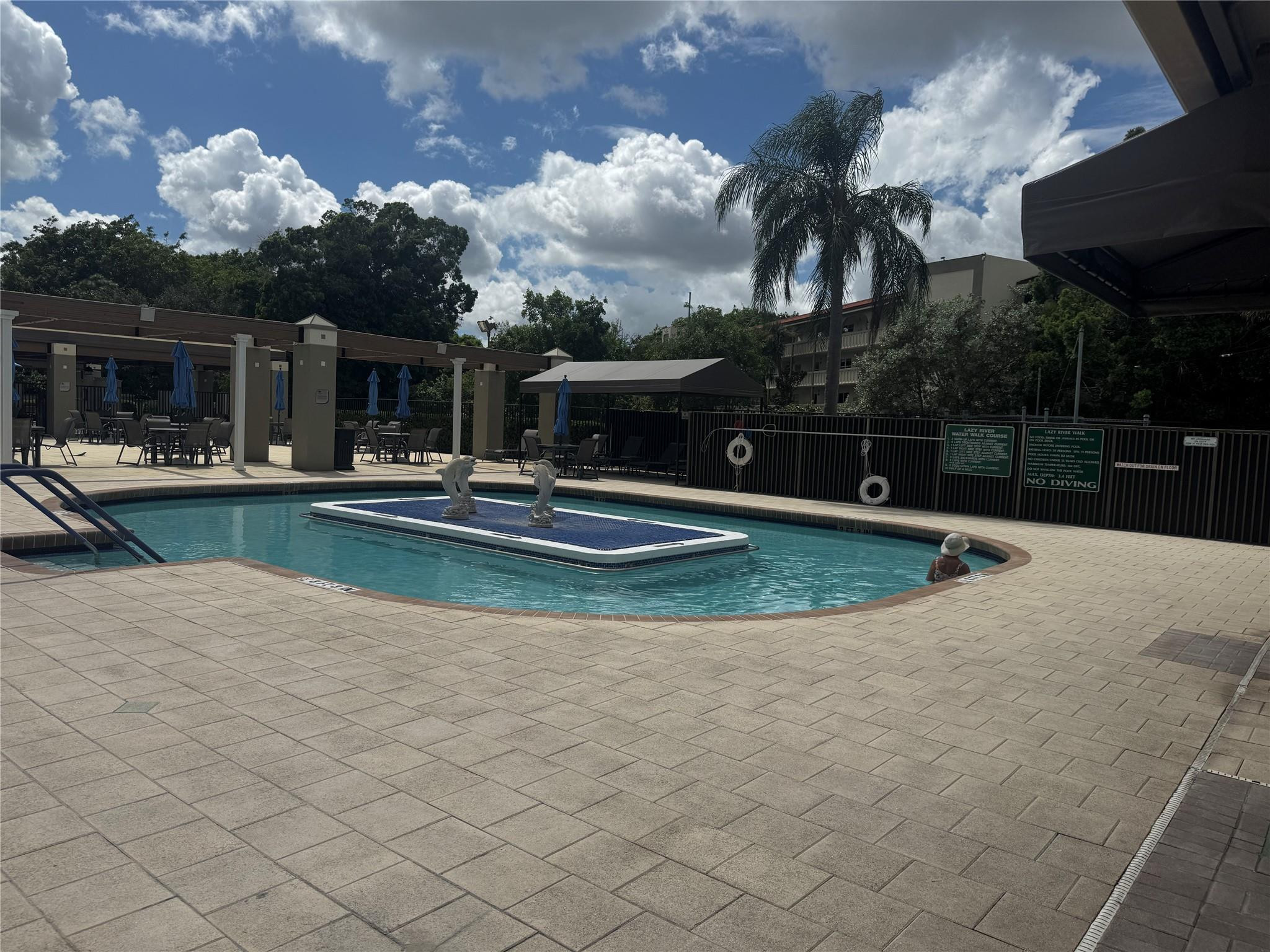 3302 Aruba Way, Unit M1 Coconut Creek, FL 33066 - Photo 33 of 58 a view of a house with swimming pool and sitting area