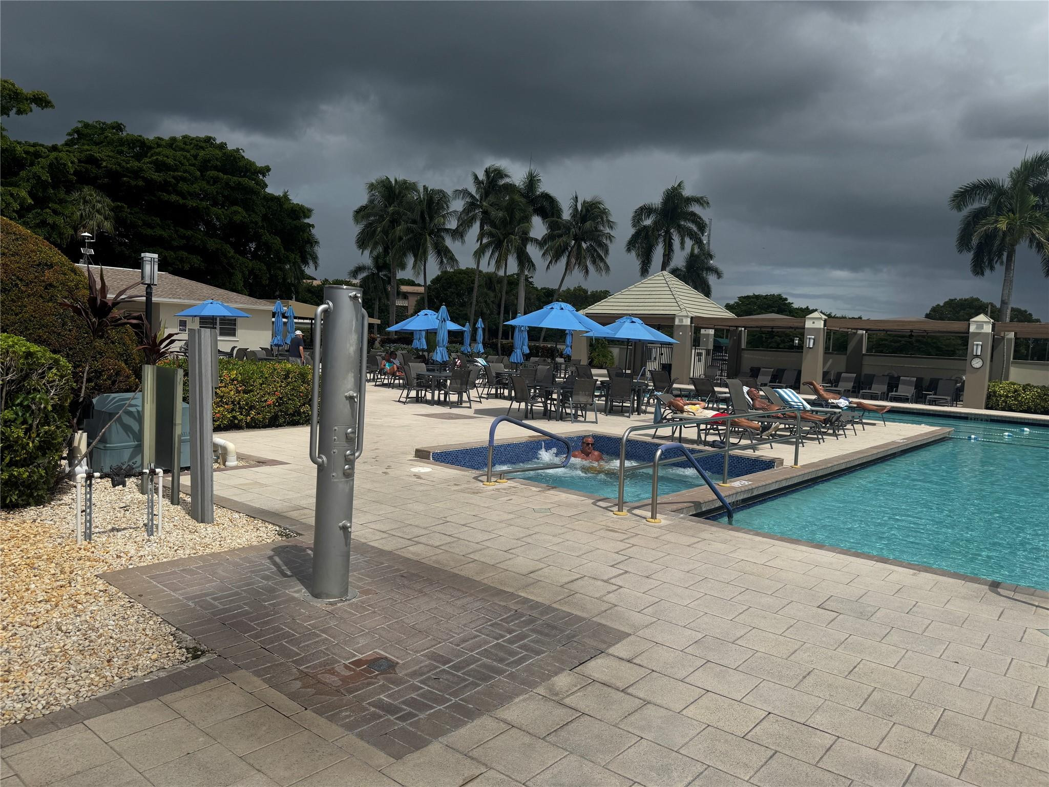 3302 Aruba Way, Unit M1 Coconut Creek, FL 33066 - Photo 34 of 58 a view of a patio with a table and chairs