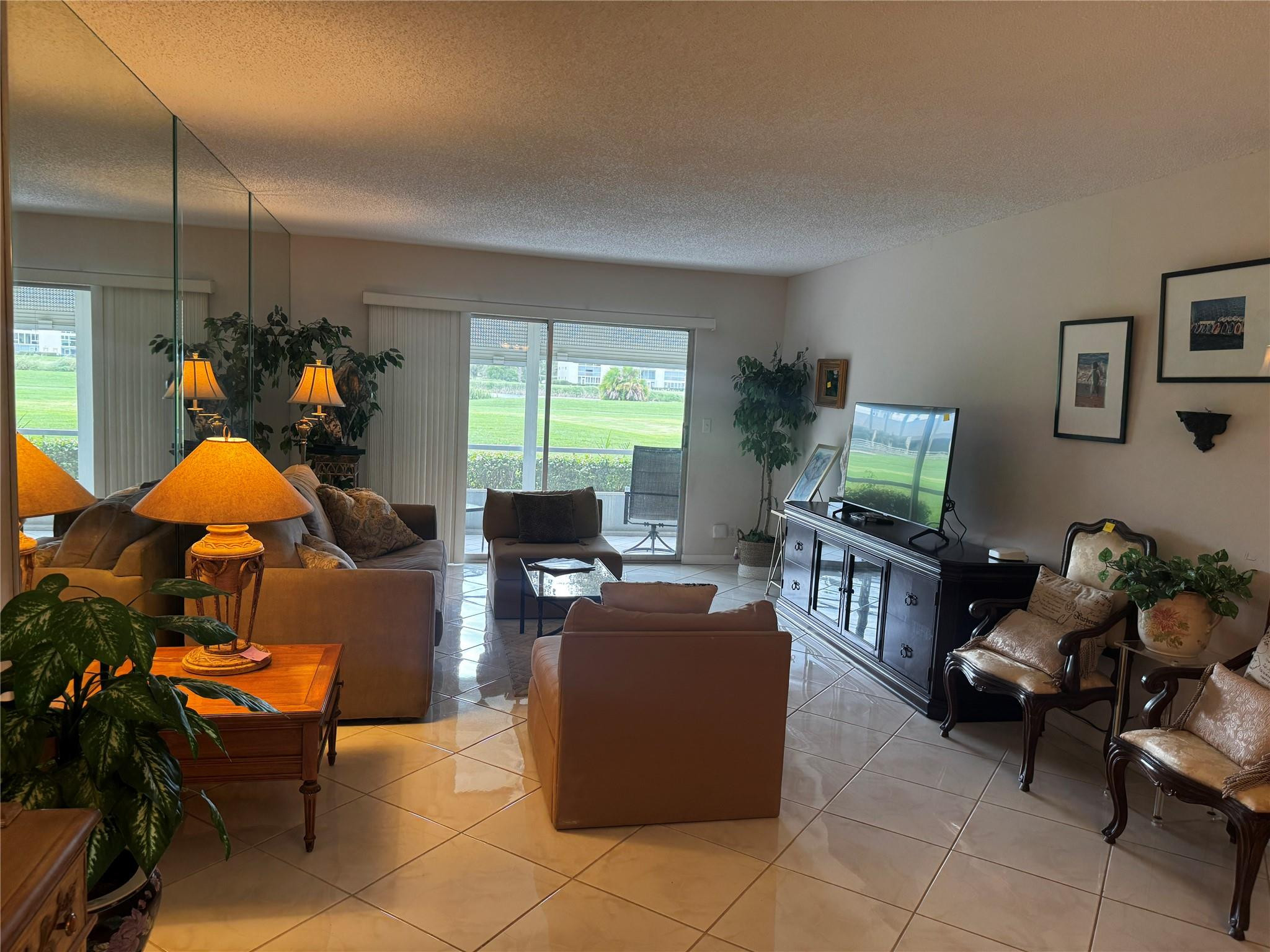 3302 Aruba Way, Unit M1 Coconut Creek, FL 33066 - Photo 7 of 58 a living room with furniture a window and a flat screen tv