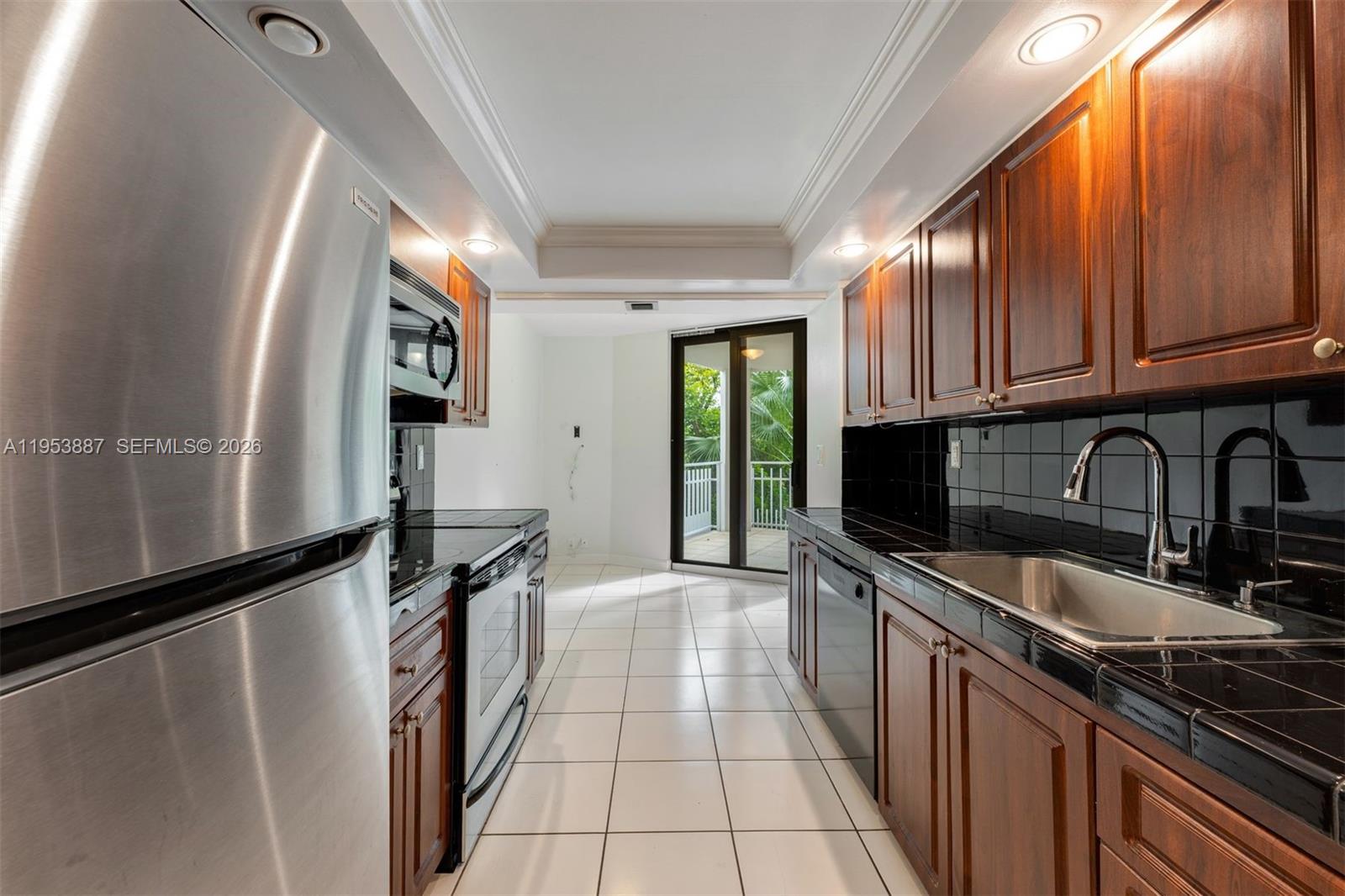 2000 Towerside Terrace, Unit 608 Miami, FL 33138 - Photo 11 of 44 a kitchen with stainless steel appliances granite countertop a sink stove and refrigerator