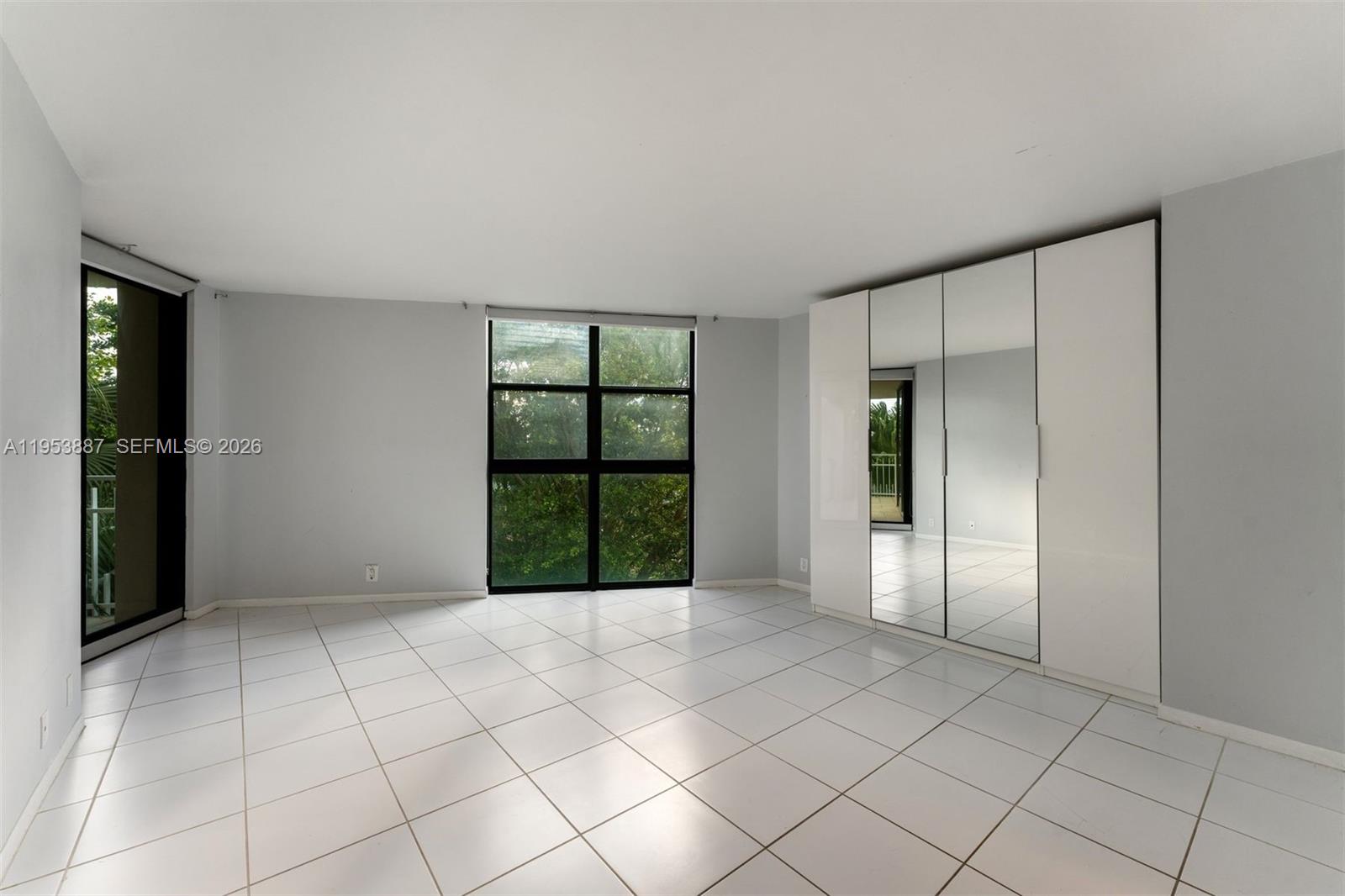 2000 Towerside Terrace, Unit 608 Miami, FL 33138 - Photo 16 of 44 a view of an empty room with window and chandelier