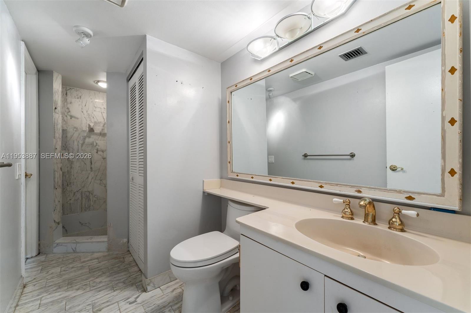 2000 Towerside Terrace, Unit 608 Miami, FL 33138 - Photo 19 of 44 a bathroom with a sink a toilet and shower