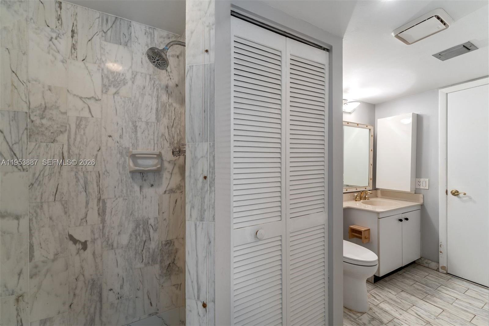 2000 Towerside Terrace, Unit 608 Miami, FL 33138 - Photo 20 of 44 a bathroom with a sink a mirror and shower view