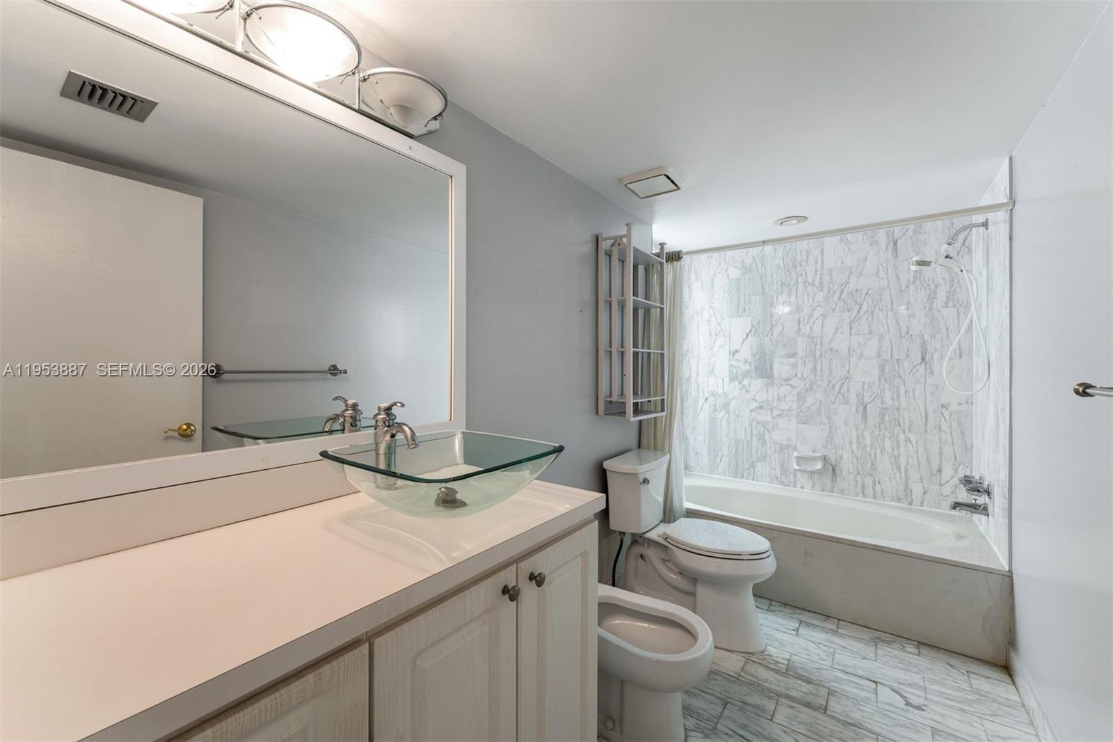 2000 Towerside Terrace, Unit 608 Miami, FL 33138 - Photo 7 of 44 a bathroom with a granite countertop sink toilet and shower