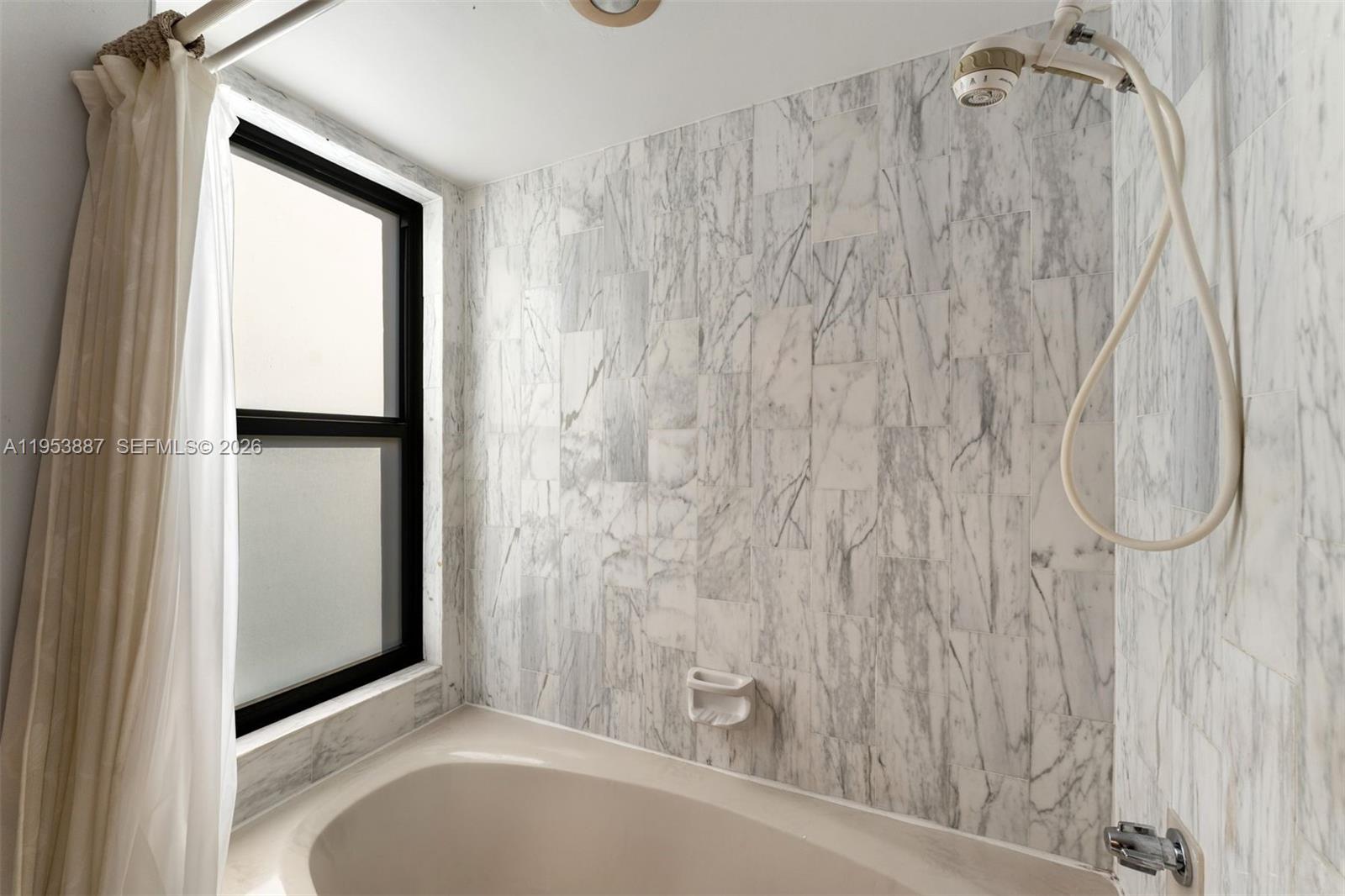 2000 Towerside Terrace, Unit 608 Miami, FL 33138 - Photo 8 of 44 a bathroom with a bathtub and shower