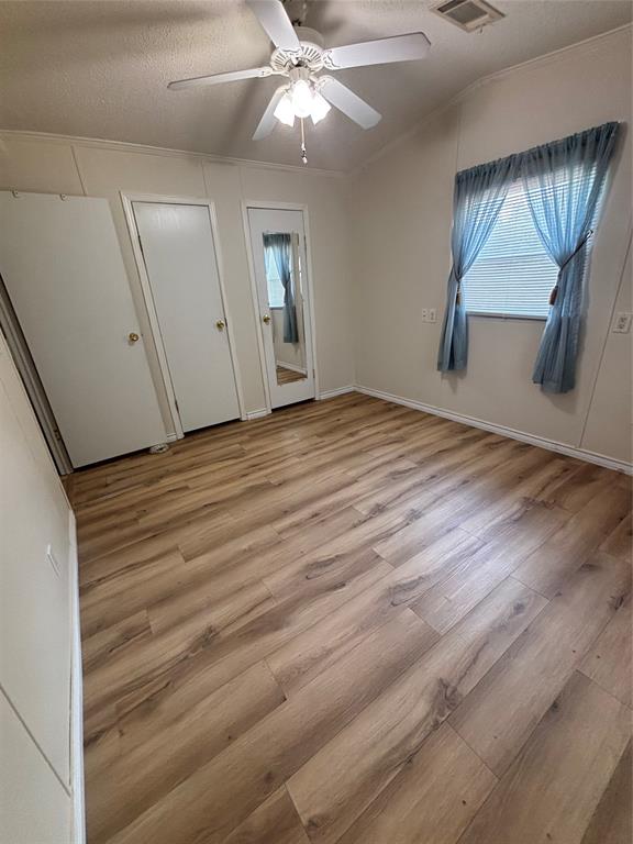 206 Holiday Rambler Drive Whitney, TX 76692 - Photo 20 of 28 Room featuring wood-finish flooring, a ceiling fan with integrated lighting, and a window with blinds