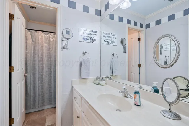 a bathroom with a double vanity sink mirror and shower