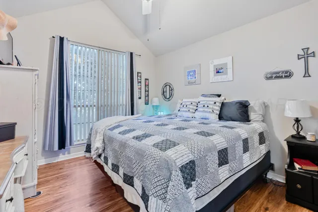 a bedroom with bed and wooden floor