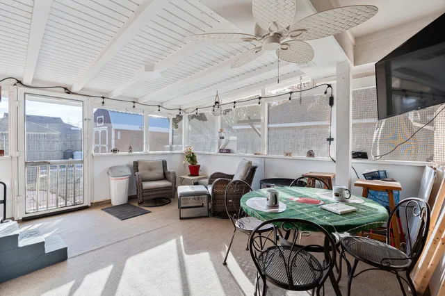 a open kitchen with stainless steel appliances a table and chairs