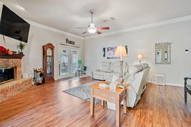 a living room with fireplace furniture and a flat screen tv