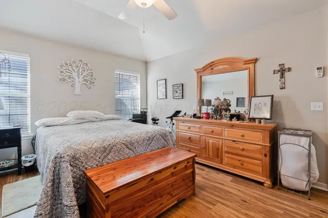 a bedroom with a bed and a dresser in it