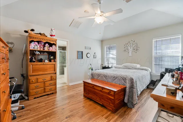 a spacious bedroom with a bed closet and flat tv screen