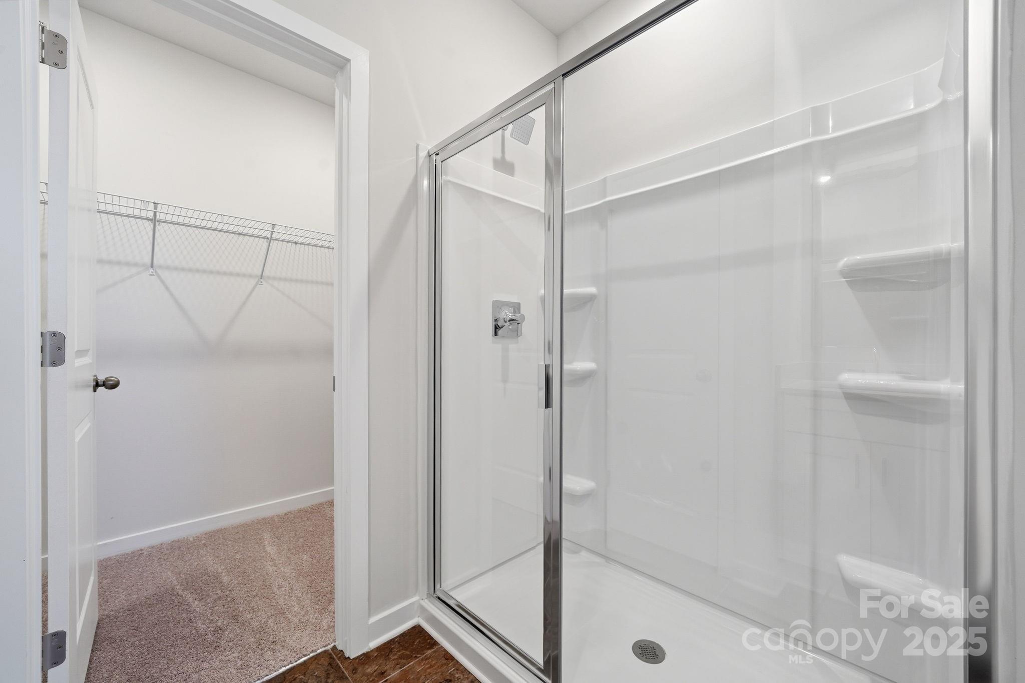 8038 Midas Lane Locust, NC 28097 - Photo 6 of 11 a bathroom with a glass shower door