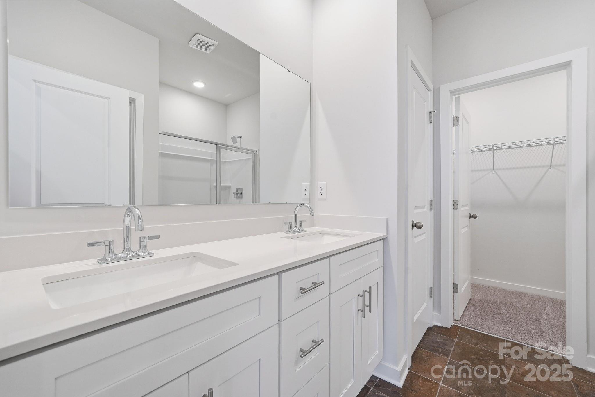 8038 Midas Lane Locust, NC 28097 - Photo 7 of 11 a en suite bathroom with a double vanity sink and a mirror