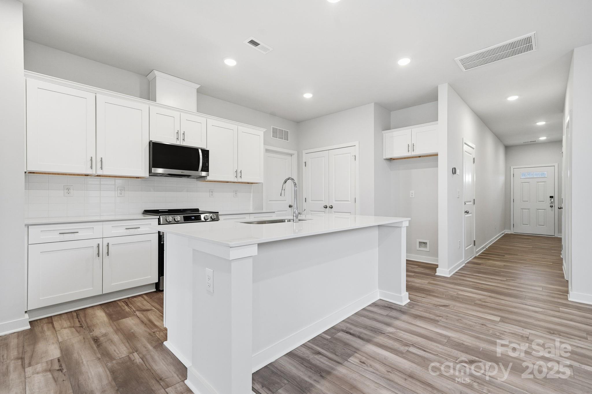 8038 Midas Lane Locust, NC 28097 - Photo 9 of 11 a kitchen with appliances a sink and cabinets
