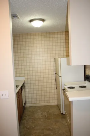 a bathroom with a sink a toilet a mirror and shower