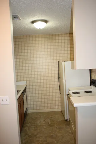 a bathroom with a sink a toilet a mirror and shower