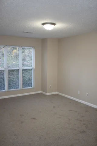 an empty room with a empty space and windows