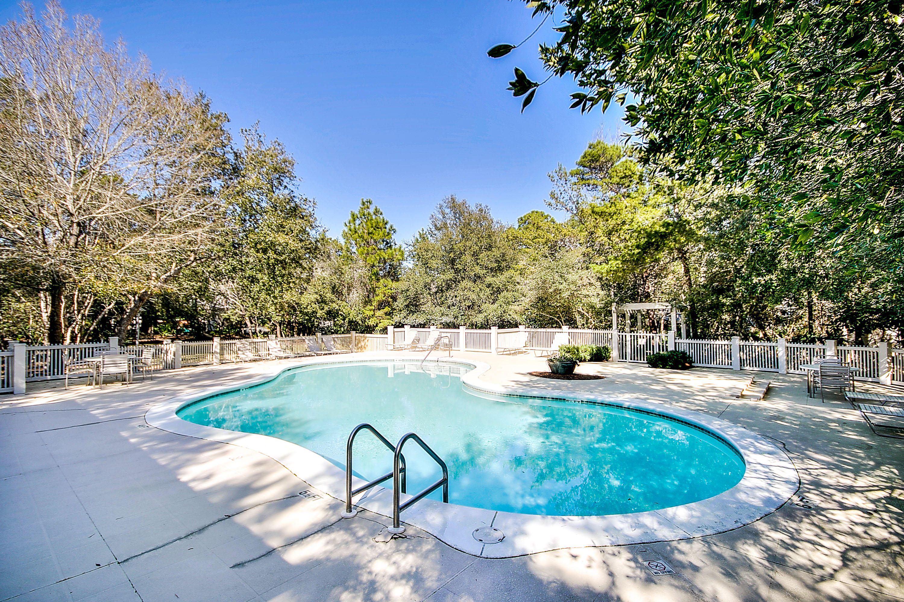 328 Wilderness Way Santa Rosa Beach, FL 32459 - Photo 39 of 49 a view of a swimming pool with lawn chairs under an umbrella