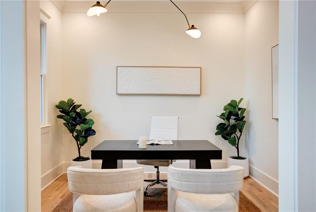 581 Sherwood Road Northeast Atlanta, GA 30324 - Photo 19 of 92 a table with a potted plant and a wooden floor