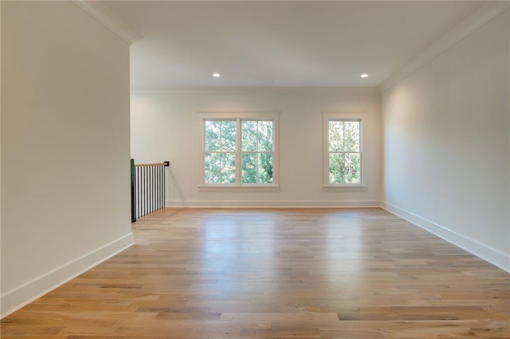 581 Sherwood Road Northeast Atlanta, GA 30324 - Photo 22 of 92 an empty room with wooden floor and windows