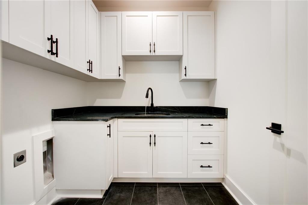 581 Sherwood Road Northeast Atlanta, GA 30324 - Photo 34 of 92 a kitchen with white cabinets and sink
