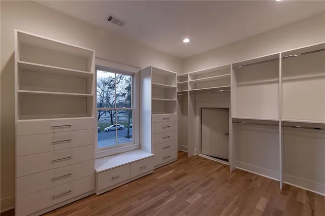 a view of walk in closet with empty racks