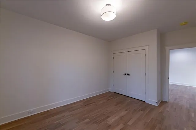 a bathroom with a granite countertop sink a mirror and a bathtub