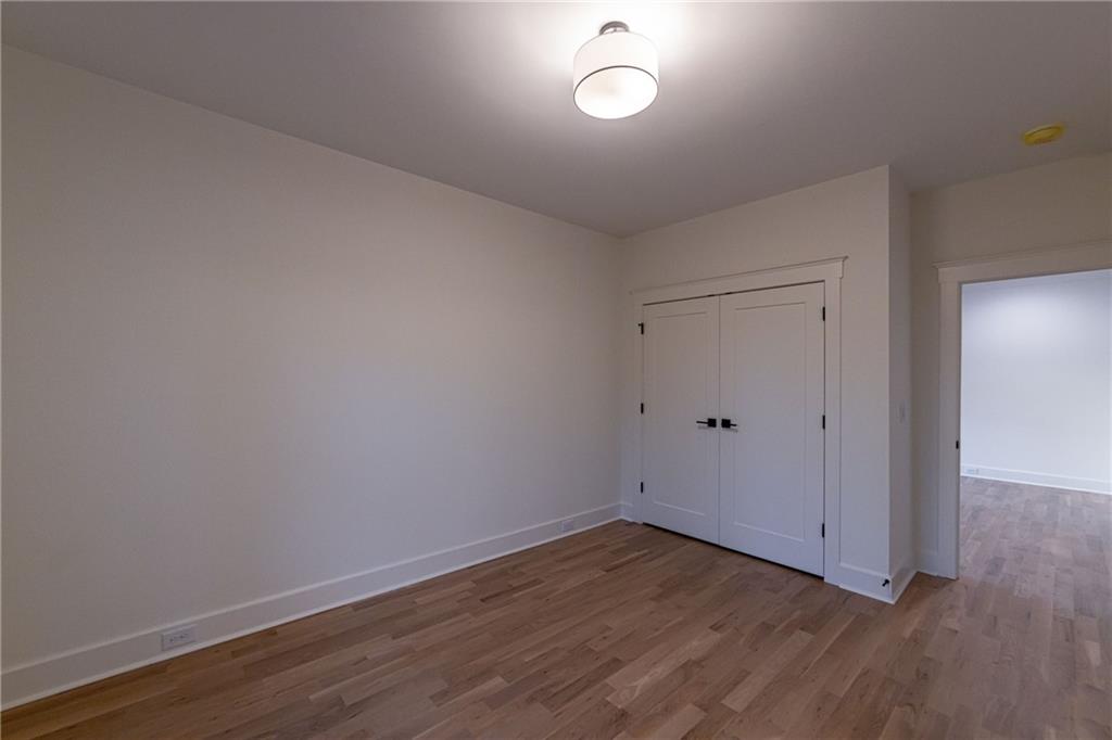 581 Sherwood Road Northeast Atlanta, GA 30324 - Photo 49 of 92 a view of a room with wooden floor and white walls
