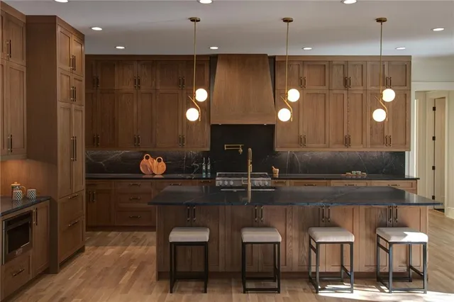 a kitchen with granite countertop cabinets and oven