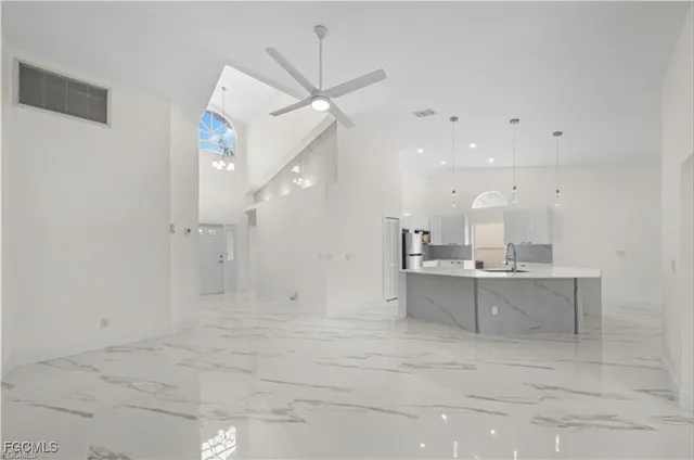 a view of a kitchen with a sink stainless steel appliances and cabinets
