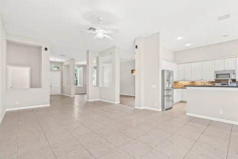 a view of a kitchen with refrigerator and cabinets
