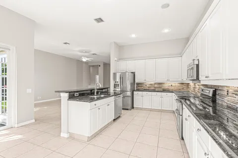 a kitchen with stainless steel appliances granite countertop a sink and a stove
