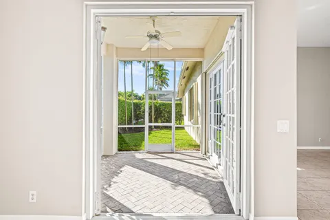 an empty room with a window and a fan