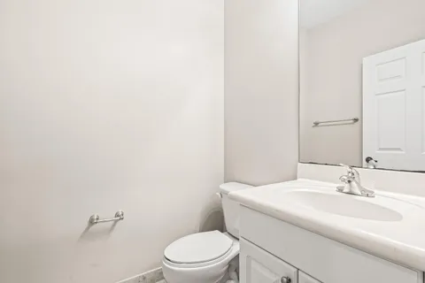 a spacious bedroom with a bed and a chandelier